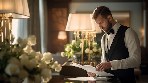 A professional hotel staff member attending to a charmingly decorated suite.