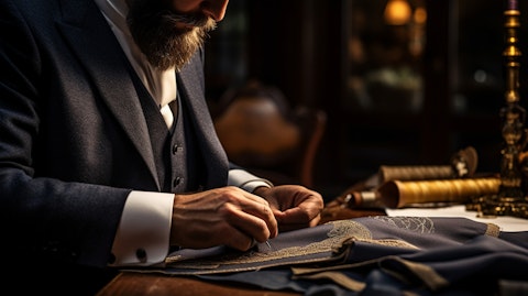 A seasoned tailoring professional hand sewing with intricate precision a formal suit.