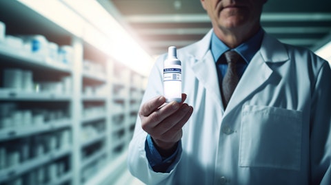 A white-coat wearing pharmacist holding a bottle of a specialized therapeutic product.