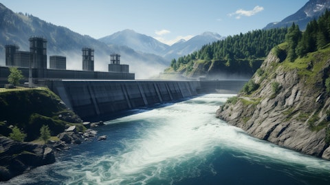 A panoramic view of a hydroelectric power plant with mountains and a river in the background.