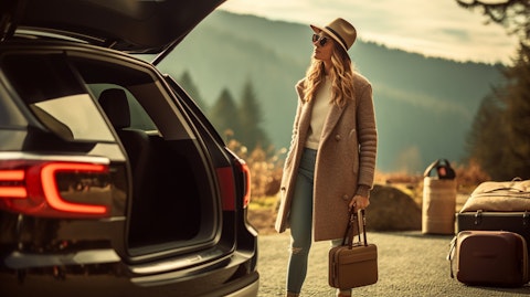 A woman traveling in a luxury station wagon, showcasing the company's exclusive luggage and travel items.