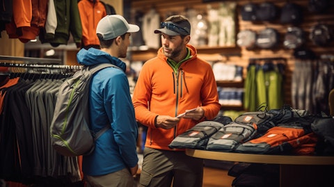 A manager in a sporting goods store giving a customer advice on outdoor equipment.