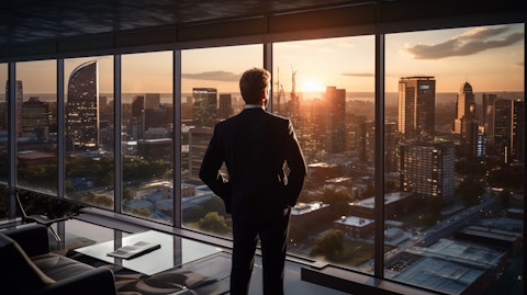 An executive in the foreground overlooking a sprawling development office space.