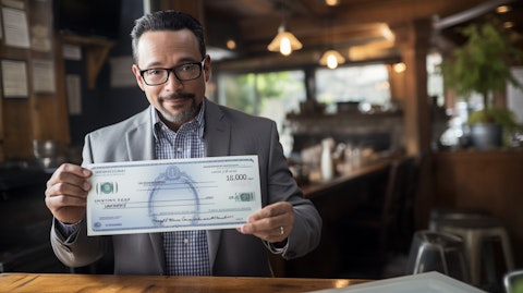 An entrepreneur in a small business receiving a loan check from the Small Business Administration (SBA).