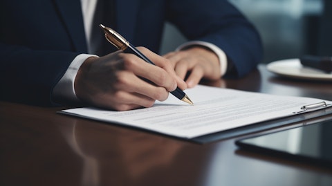 A close-up of a hand signing a loan agreement, symbolizing the trust between the company and its clients.