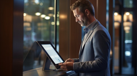 A customer using a touch-screen tablet at a bank branch to access their accounts.