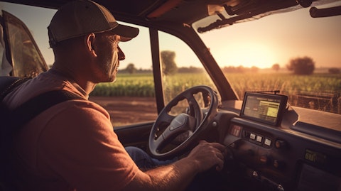 A farmer driving a tractor and working the land reflecting the company's core values.
