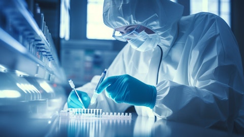 A lab technician carefully handling a vial of antibodies for an antibody drug conjugate.