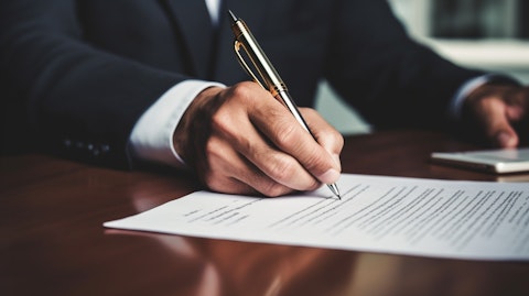 A close-up of a hand signing a contract, symbolizing deals being made in private equity and buyouts.