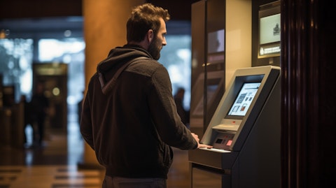 A customer using an ATM machine in a bank lobby.
