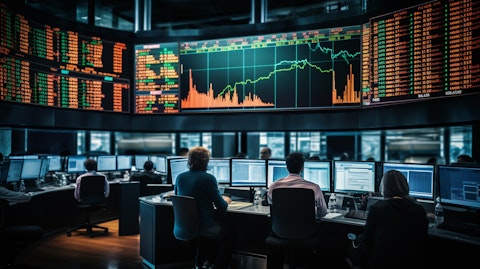 The interior of a busy trading floor, the stock ticker on a screen showing dramatic changes in share prices.