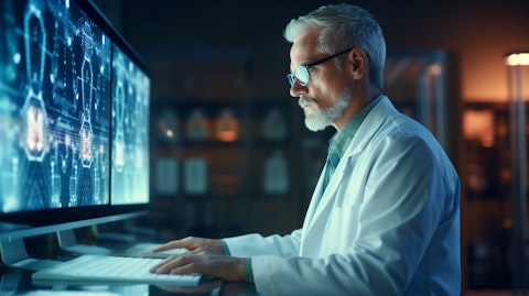 A doctor in a lab coat looking at a medical education computer screen, symbolizing digital health services.