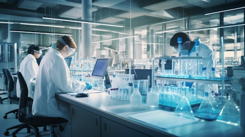 A laboratory filled with researchers in lab coats working on genetic testing.