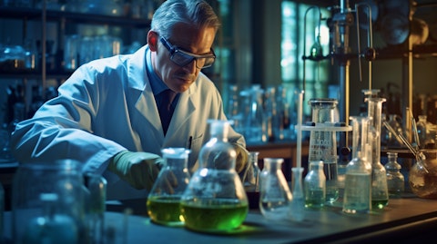 A chemist in a laboratory mixing specialty chemicals and materials for research.