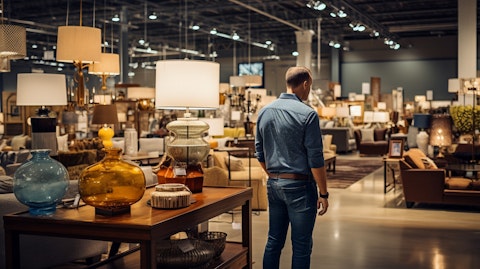 A customer browsing a variety of residential furniture and accessories in a retail store.