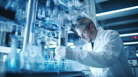 A biotherapeutics scientist in a lab coat examining a monoclonal antibody.