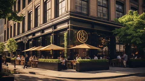 A bustling, upscale restaurant with the company's logo atop the building.
