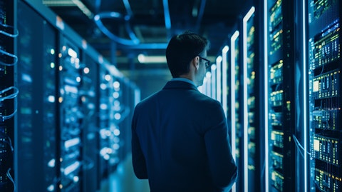 A network engineer monitoring a large server cluster in a busy datacenter.