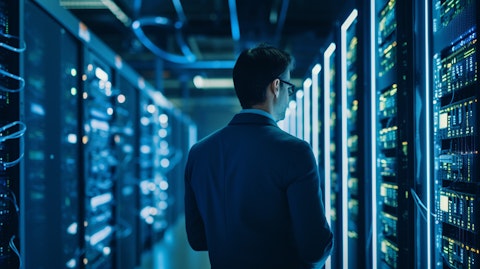 A network engineer monitoring a large server cluster in a busy datacenter.