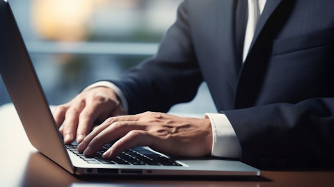 A close-up of a senior executive in a suit, typing away on a laptop to complete the latest investments in debt securities and equity interests.