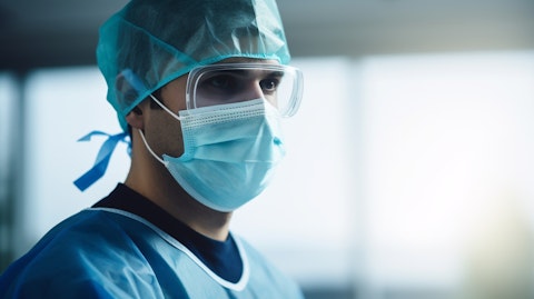 A medical technician wearing scrubs and face mask, ready to operate on a patient in the operating room.