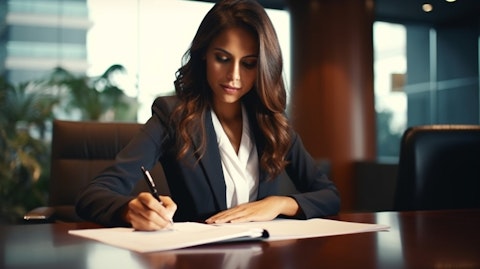 A businesswoman signing relevant documents at a bank branch for a commercial real estate loan approval.