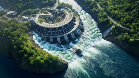 An aerial view of a hydroelectric power plant with winding river below.