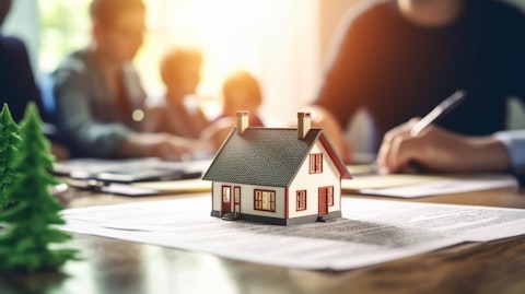 A person signing a document on their kitchen table, a family and home in the background.