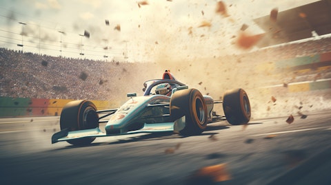 A professional race car driving around a track with a crowd of cheering fans.