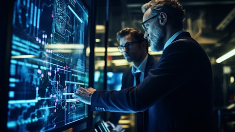 A computer engineer demonstrating the company's cybersecure platform to a client.