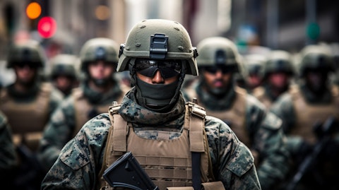 A U.S. Marine in full body armor standing in formation in a parade.