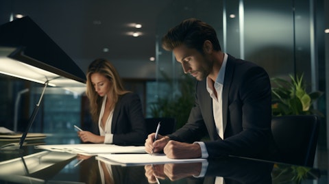 A businessman and a woman signing documents in a corporate office.