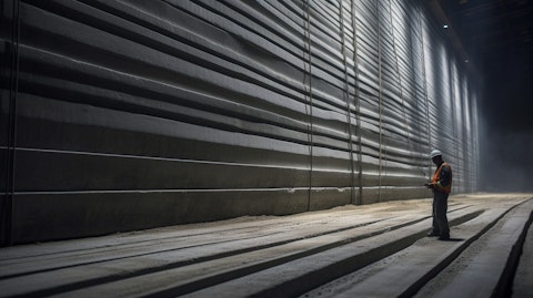 An engineer inspecting a complex set of prestressed concrete strands inside a factory.