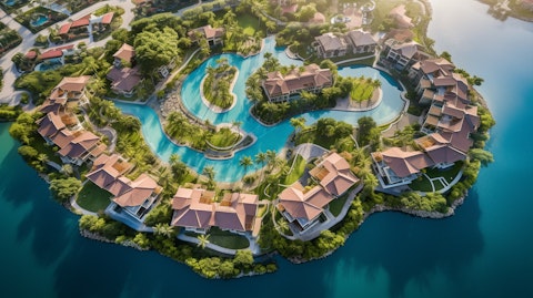 Aerial photo of sprawling resort complex with a lake in the background.