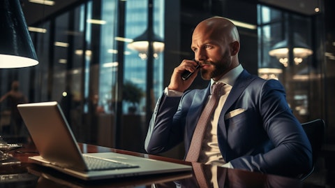 A businessman in a suit on a conference call, discussing important financial strategies.