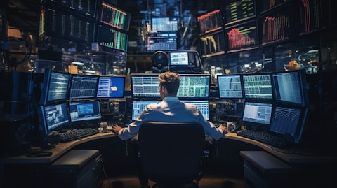 A trader on the floor of a bank's trading room, surrounded by sophisticated electronic equipment.
