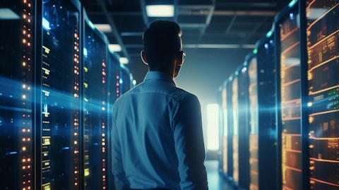 A tech entrepreneur in front of a busy data center, inspecting a server bank.