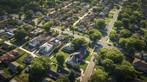 Aerial view of a neighborhood with houses and a real estate brokerage office.
