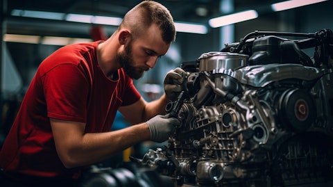 A skilled technician installing a seal on a car engine in a Cooper-Standard Holdings factory.