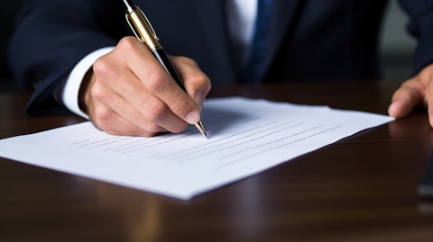 A hand signing a bank document, emphasizing the security and trust offered in its services.
