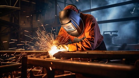 A metal fabricator welding a steel structure.