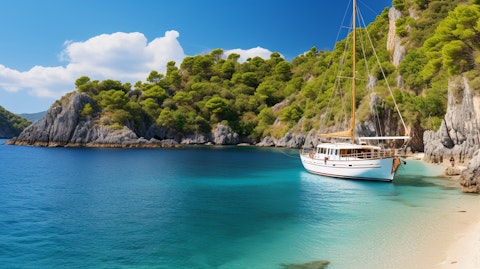 A high-end vacation yacht sailing through turquoise waters of a secluded cove.