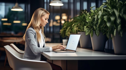 A tech-savvy real estate broker working hard, consulting with her clients and tapping away at her laptop.