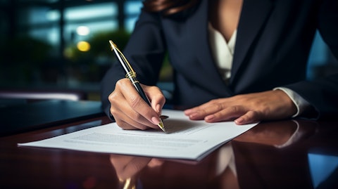 A businesswoman signing for a commercial loan, indicating the company's credit services.