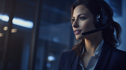 A person with a headset providing technical support via help desk services to a customer.