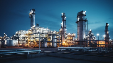 An industrial plant producing natural gas compression equipment, illuminated by night.