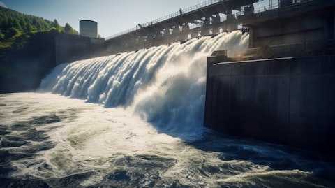 A vast hydroelectric generation plant with a powerful waterfall cascading downwards.