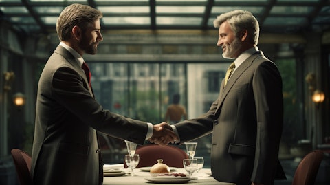 A suited executive shaking hands, celebrating the success of a major new deal.