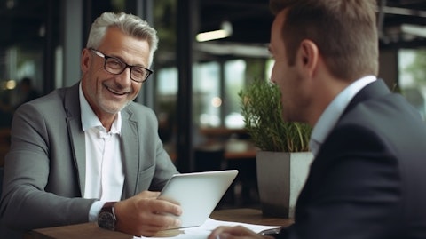 An experienced insurance agent explaining the benefits of an insurance product to a customer.