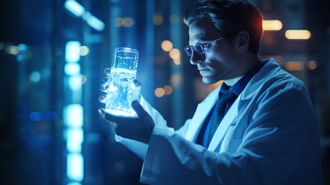 A scientist in a lab coat holding a vial filled with a blue glowing liquid, representing the clinical-stage biopharmaceutical company's research in rare diseases.